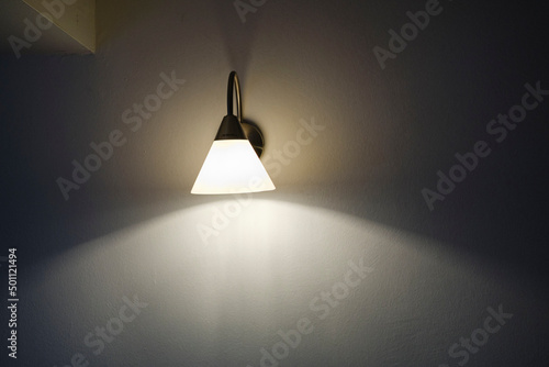 designer wall lamp on white wall, twilight