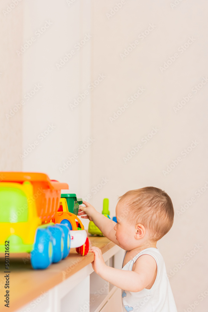 Little child playing with toy cars at home Little child playing with toy cars at home
