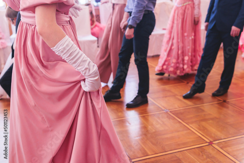 Couples dance on the historical costumed ball in historical dresses, classical ballroom dancers dancing, waltz, quadrille and polonaise in palace interiors on a wooden floor, opera gloves close-up © tsuguliev