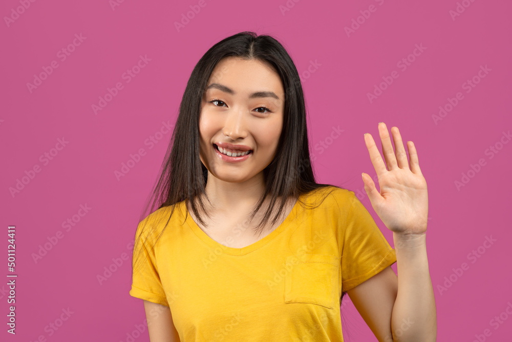 Portrait of cheerful asian lady waving hand at camera, positive korean woman gesturing hi, greeting somebody Portrait of cheerful asian lady waving hand at camera, positive korean woman gesturing hi, greeting somebody