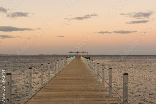 Wooden pontoon at sea, Golden sea sunset. © Angelov