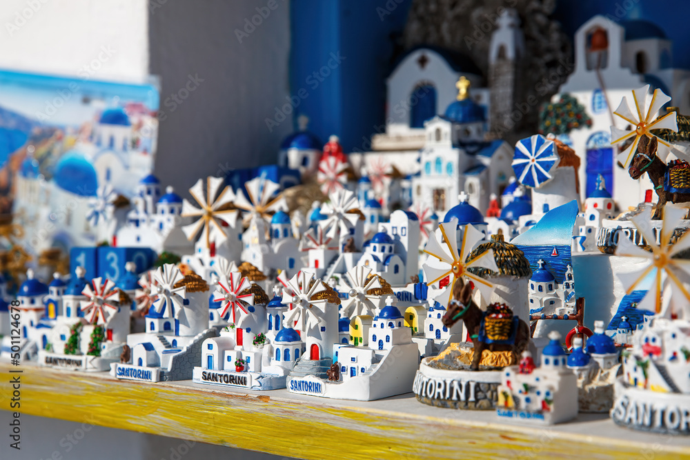 Windmills and churches - souvenirs on Santorini island, Greece.