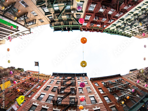 Looking up at historic buildings on Mott Street in the Chinatown neighborhood of New York City with fisheye lens effect photo