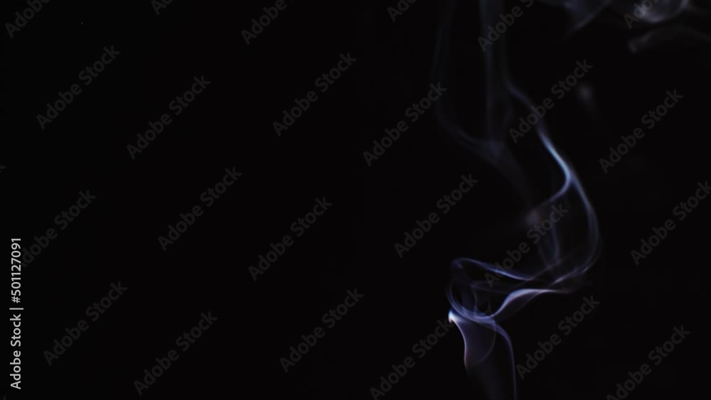 Realistic cloud smoke with a streamlined pattern. Abstract blue smoke on dark background in slow motion. Realistic cloud smoke with a streamlined pattern. Abstract blue smoke on dark background in slow motion.