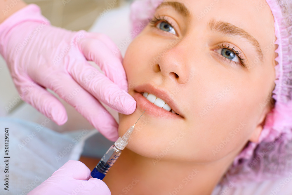 Image of a young beautiful woman dressed as a patient, lying on a couch in a cosmetology clinic. Image of a young beautiful woman dressed as a patient, lying on a couch in a cosmetology clinic.