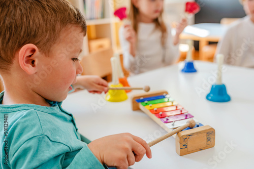 Kindergarten Children Learning Music Using Various Colorful  Instruments. Learning Music for Kids using Colors. Montessori Music Activities for Preschoolers. photo