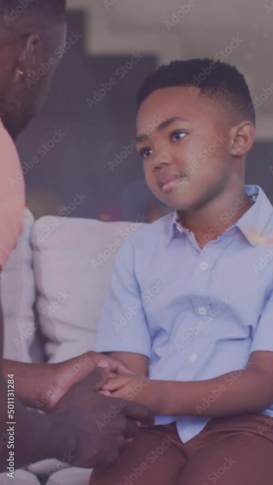 Animation of lights over african american father and son having serious conversation Animation of lights over african american father and son having serious conversation