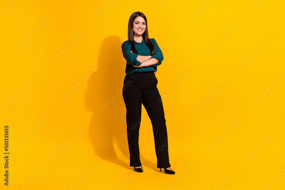 Full size photo of young cheerful woman crossed hands smart wear modern outfit isolated over yellow color background Full size photo of young cheerful woman crossed hands smart wear modern outfit isolated over yellow color background