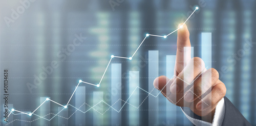 Hand touching graphs of financial indicator market analysis chart