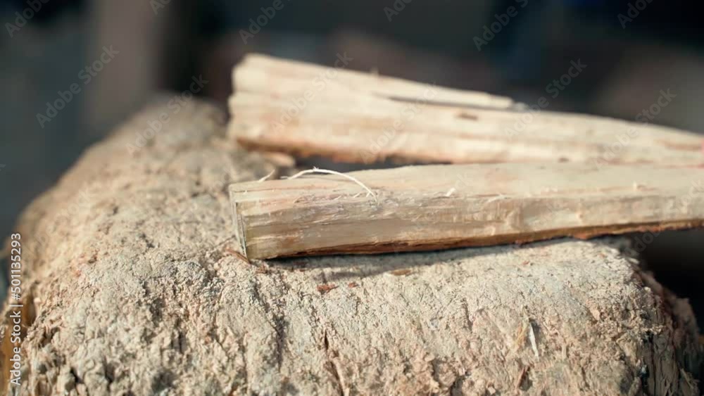 Close-up of splitting wood into small chips to start a fire