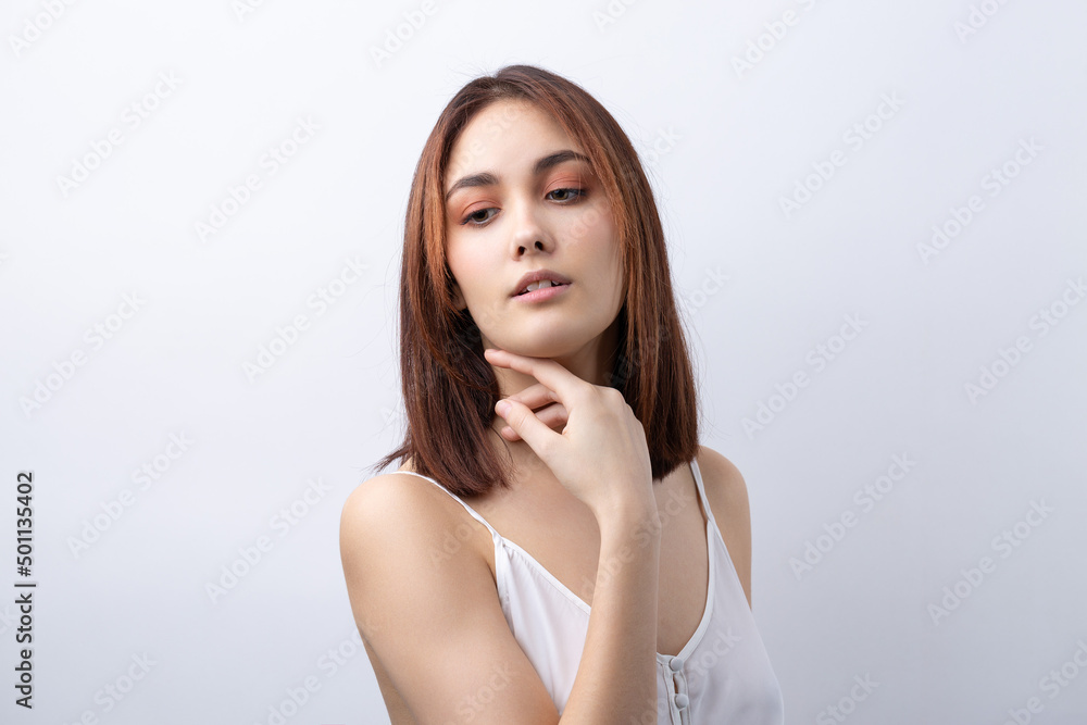 Fototapeta premium Beautiful smiling woman with clean skin, natural make-up and white teeth on a gray background