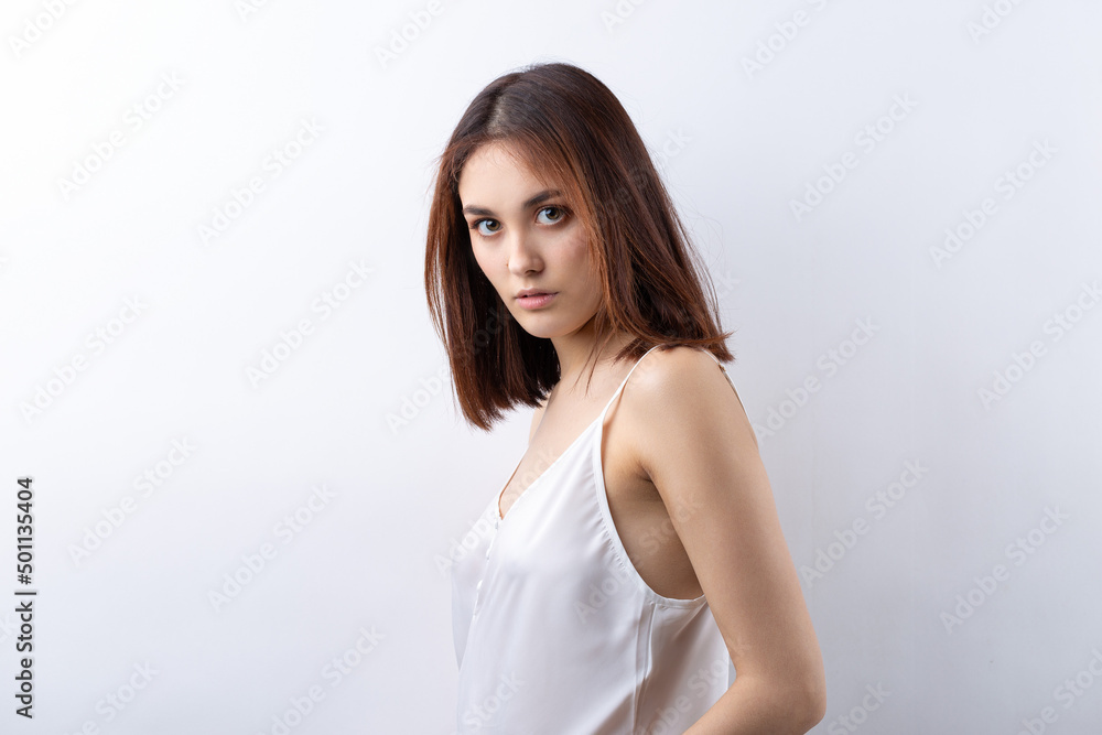 Beautiful smiling woman with clean skin, natural make-up and white teeth on a gray background Beautiful smiling woman with clean skin, natural make-up and white teeth on a gray background
