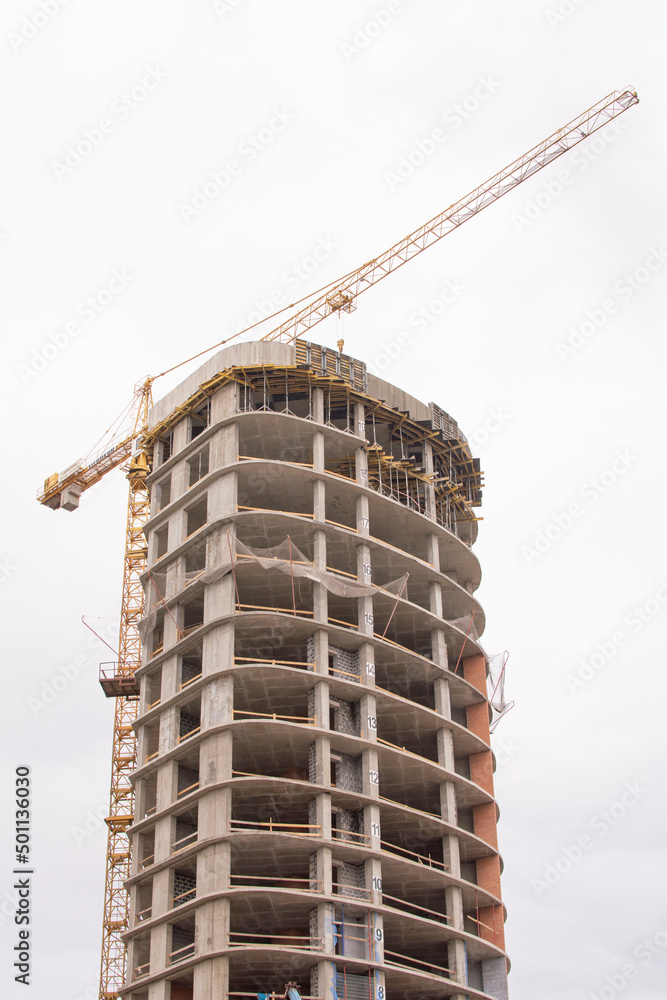 Construction of a high-rise building with a crane. Construction of buildings using formwork in Minsk Construction of a high-rise building with a crane. Construction of buildings using formwork in Minsk