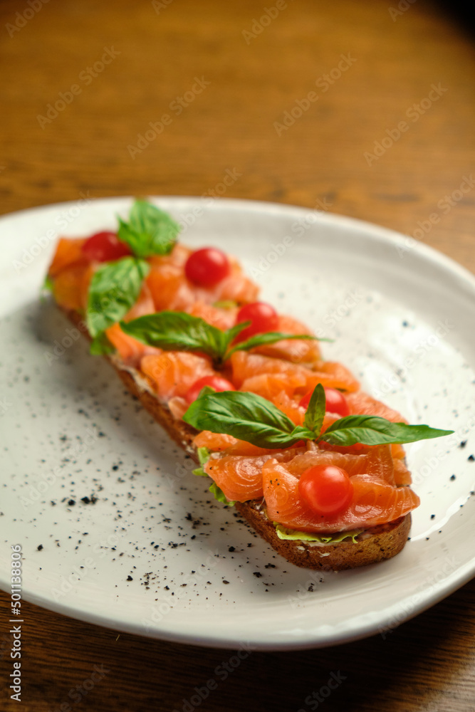 Bruschetta with pickled trout and salmon basil and tomatoes Bruschetta with pickled trout and salmon basil and tomatoes