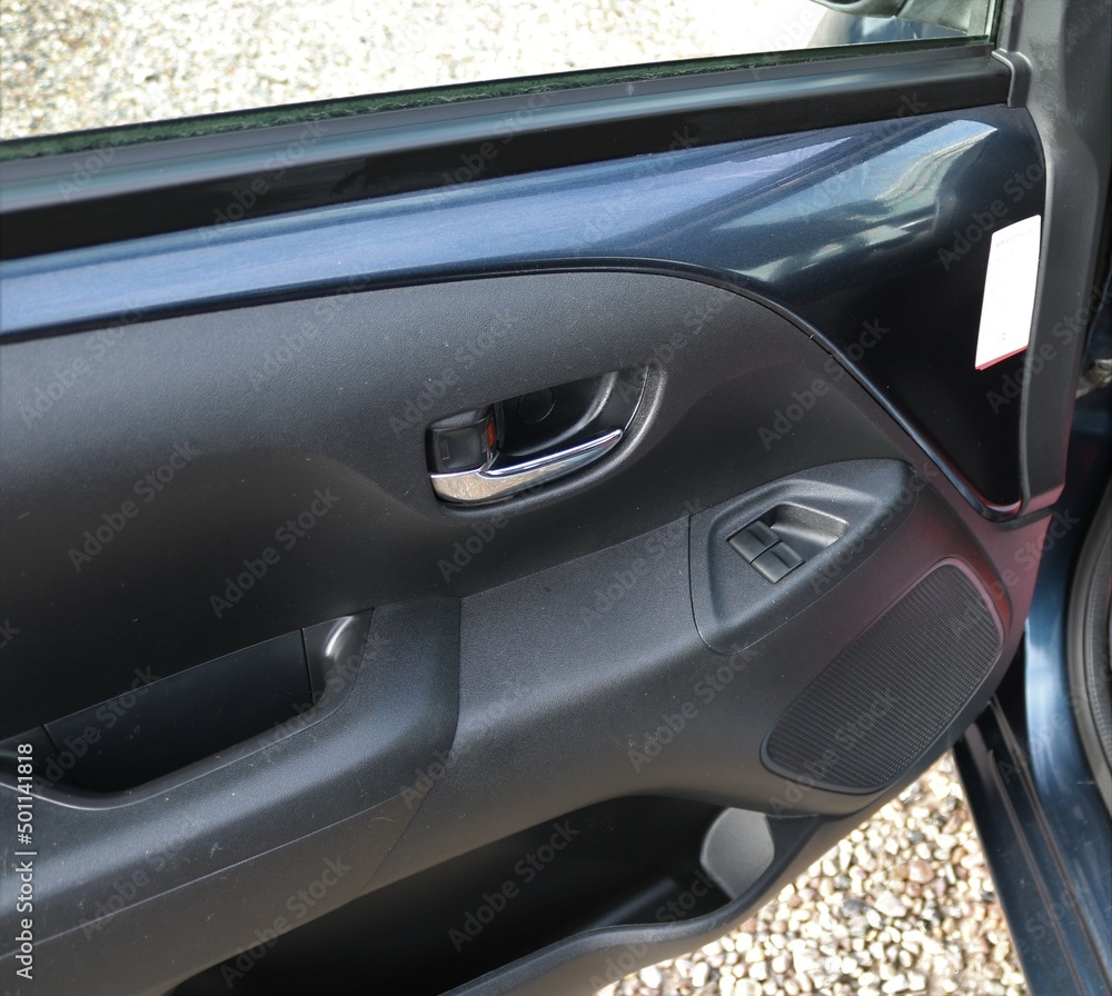 Car door handle with adjustment knobs.