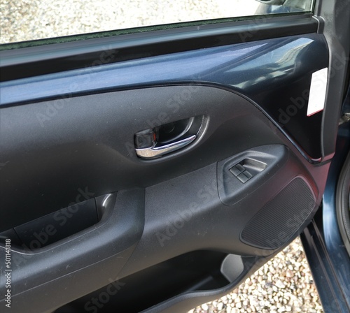 Car door handle with adjustment knobs.