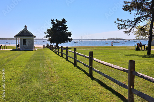 Seaside park with large green lawn and a wooden fence in Hyannis Port, Cape Cod, MA photo