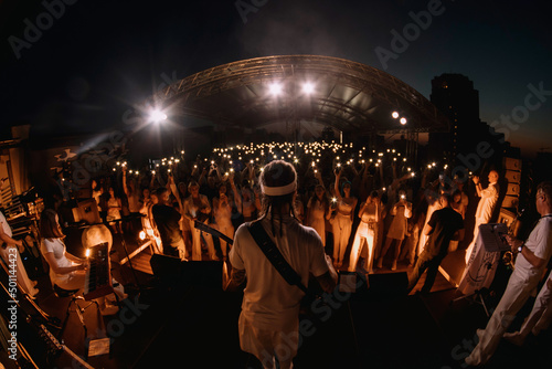 artist on stage with guitar