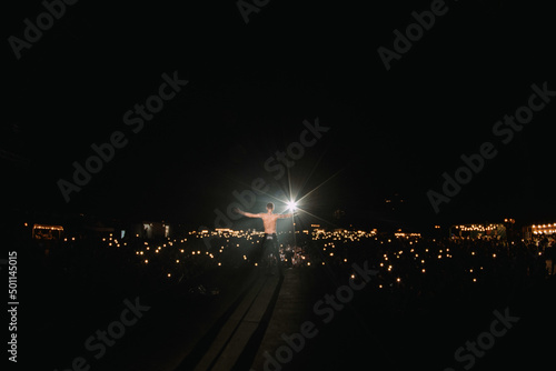 a man stands and a spotlight shines on him