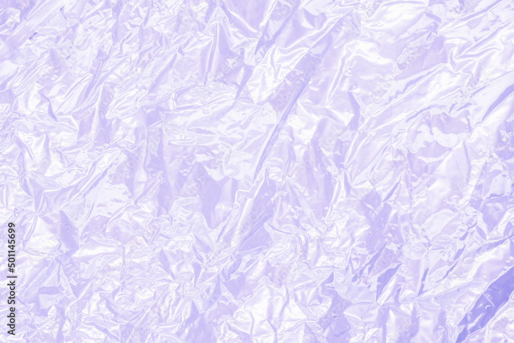 Full frame creased shiny metal foil sheet in trendy lilac violet color. Background or backdrop