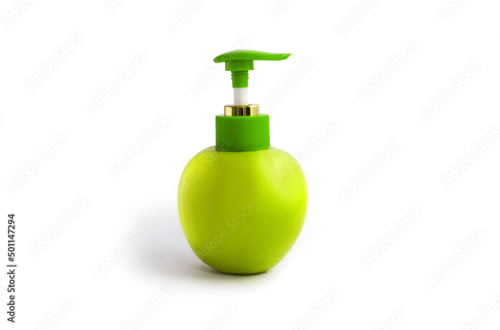 Apple with a dispenser on a white background. Green juicy apple with a plastic dispenser on an isolated white background. The concept of natural cosmetic creams or soaps Apple with a dispenser on a white background. Green juicy apple with a plastic dispenser on an isolated white background. The concept of natural cosmetic creams or soaps
