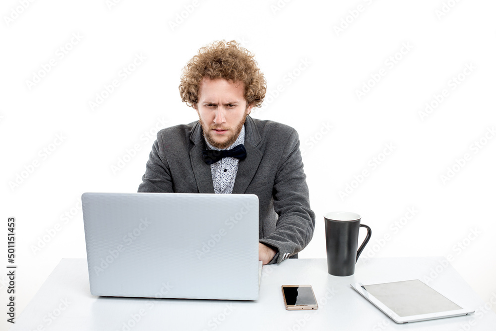Businessman looking at his Laptop, huge cup of coffee Businessman looking at his Laptop, huge cup of coffee