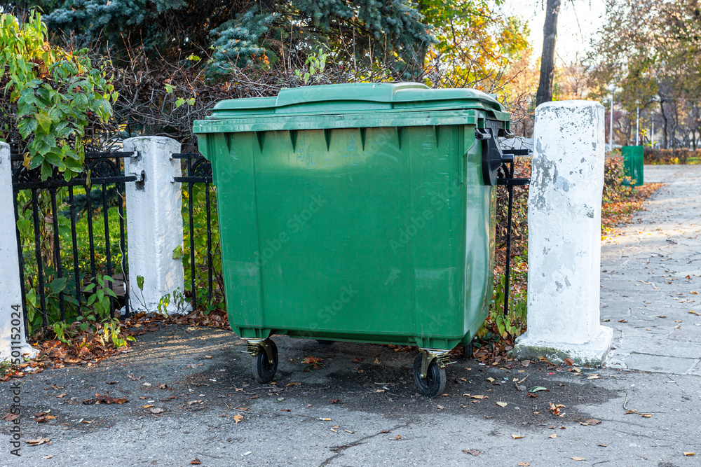 Green recycling container at the city park Green recycling container at the city park