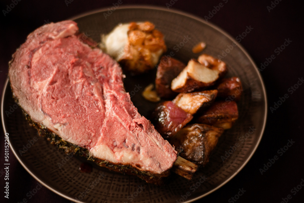 Serving of prime roast with roasted potatoes and garlic Serving of prime roast with roasted potatoes and garlic