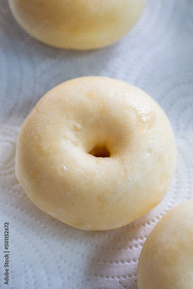 A round Japanese homemade doughnut or Bomboloni, sweet bakery prepared for fried with hot oil. A round Japanese homemade doughnut or Bomboloni, sweet bakery prepared for fried with hot oil.