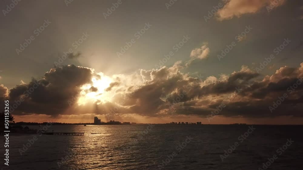 boom up of Cancun strip that cover 14 miles with a beautiful golden sunset and clouds in front of the sun that just let through sun rays
boom up of Cancun strip that cover 14 miles with a beautiful golden sunset and clouds in front of the sun that just let through sun rays