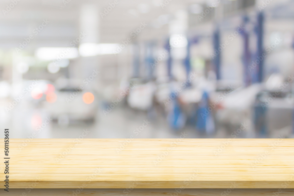 Empty wood table top with car service centre auto repair workshop blurred background Empty wood table top with car service centre auto repair workshop blurred background
