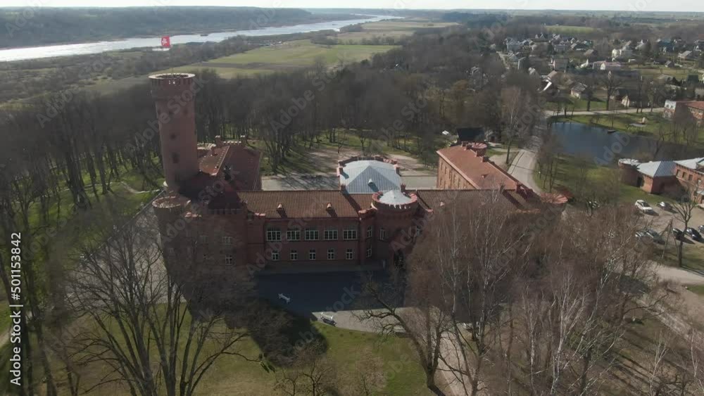 Aerial drone panorama shot of redbrick castle with tower and flag. Aerial drone panorama shot of redbrick castle with tower and flag.