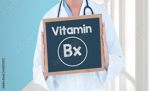 Vitamin Bx- Doctor shows information on blackboard.Doctor holding chalkboard with text. photo