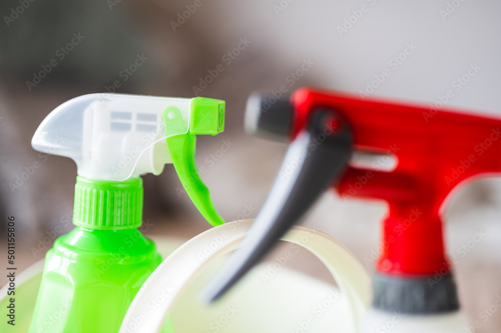 Aerosol spray bottles in plastic basket with handle, home cleaning tool for disinfection care Aerosol spray bottles in plastic basket with handle, home cleaning tool for disinfection care
