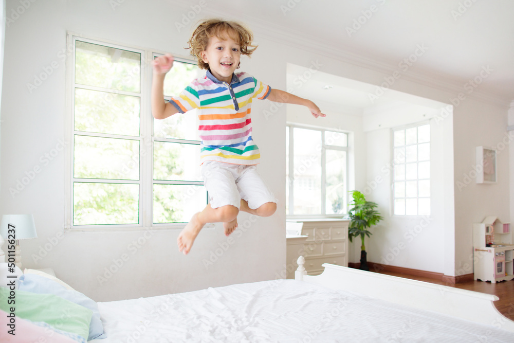 Child playing in bed. Kids room. Boy at home. Child playing in bed. Kids room. Boy at home.