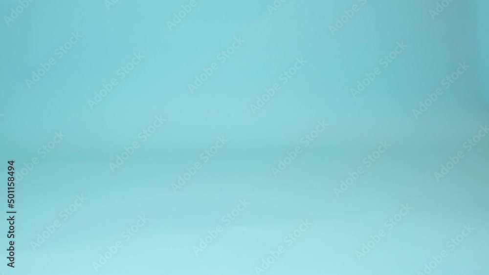 Women legs walk on the floor on a studio blue background Women legs walk on the floor on a studio blue background