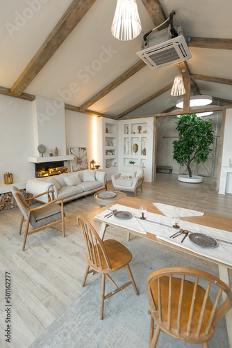 cozy warm home interior of a chic country house with an open plan, wood finishes, warm colors and a family hearth