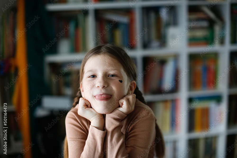 Cute child girl with pigtails with a black heart on her cheek Cute child girl with pigtails with a black heart on her cheek