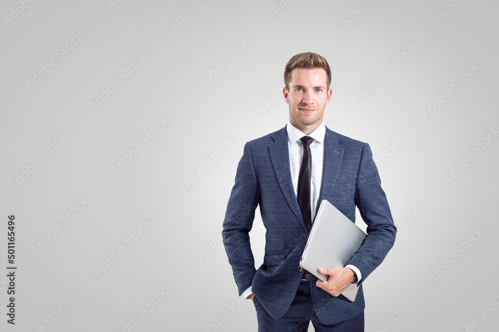 Young businessman with a laptop computer on neutral background Young businessman with a laptop computer on neutral background