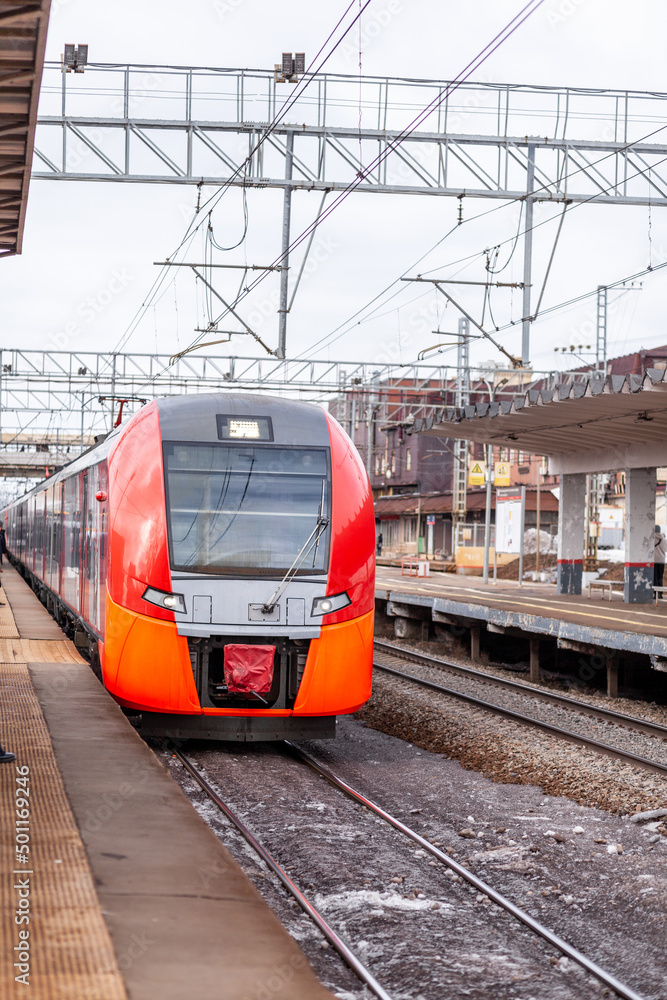 April 1, 2022, Moscow Russia. Modern high-speed train moves fast along the platform. People are waiting for the train at the station, public transport.
