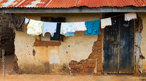 Mud brick home with clothes drying on clothes line, Uganda Africa