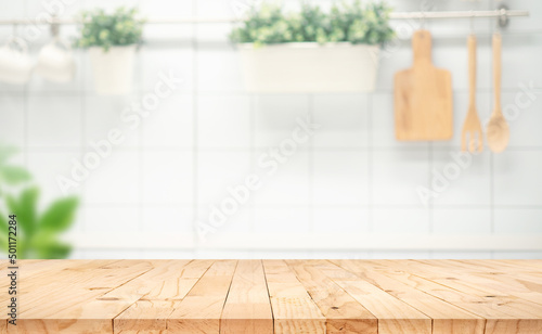 Selective focus.Wood table top on blur kitchen counter background.F