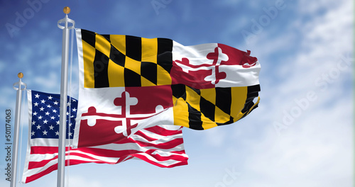 The Maryland state flag waving along with the national flag of the United States of America photo