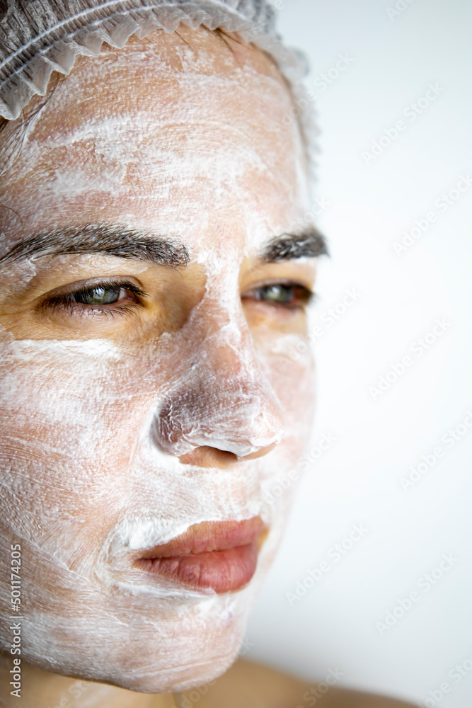 Fototapeta premium Cream mask on the face of the girl, rejuvenating face mask.