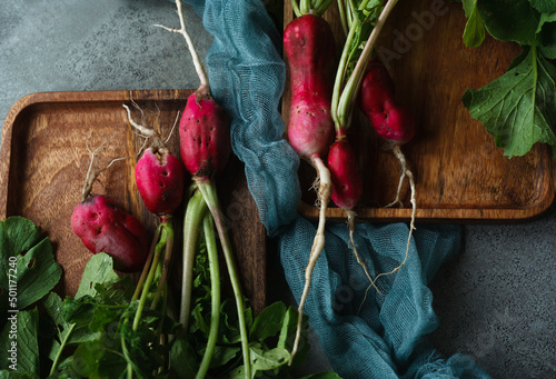 Two bunches of red radish damaged by slugs and disease, organic vegetables concept, ugly vegetables