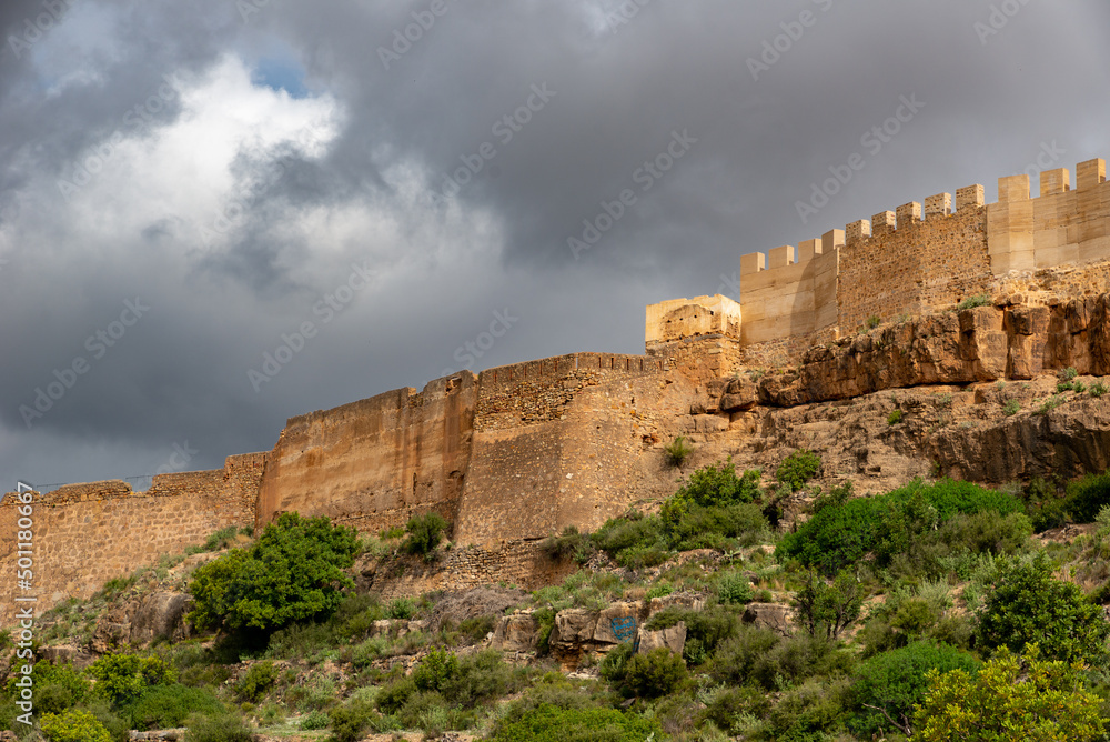 wall of an old fortress on a hill against a gloomy sky