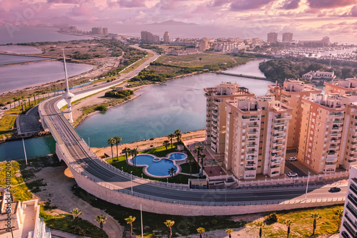 Bird's eye view of a shipping canal and a drawbridge in a tourist region in southern spain.