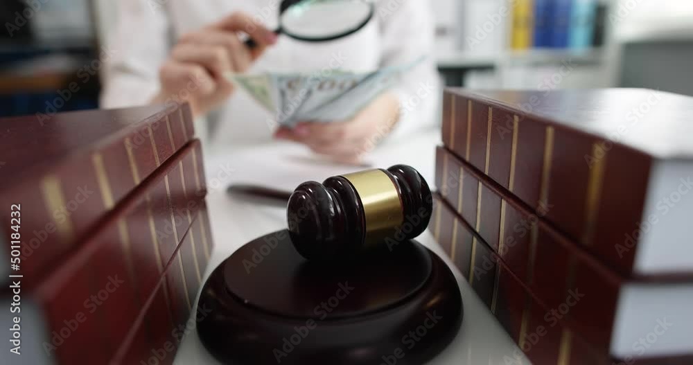Judicial gavel and judge with magnifying glass and wealth Judicial gavel and judge with magnifying glass and wealth