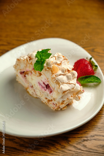 Cake with meringue roll with cream and raspberries