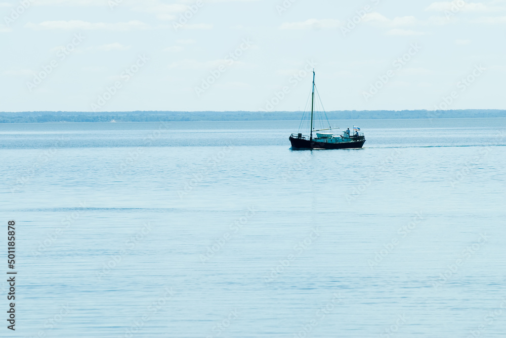Obraz premium Fishing ship goes via Baltic sea channel to base